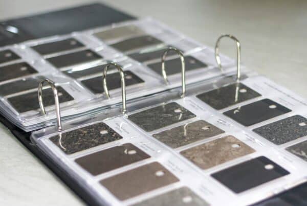 a close up on countertop options in a swatch book provided by a remodeling company