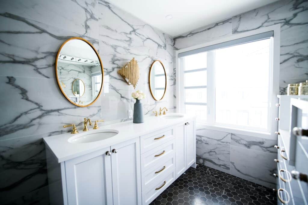 beautiful unique bathroom remodel with marble backsplash walls and hexagon tile