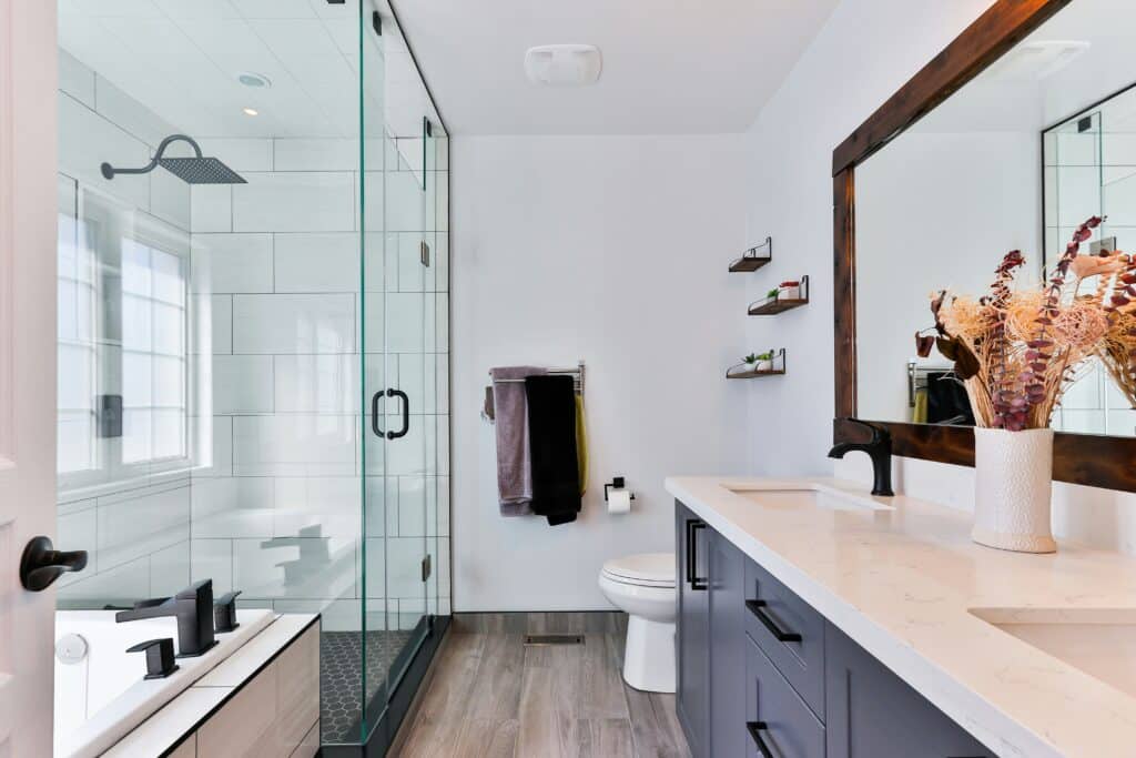 remodeled bathroom with slate grey cabinets and double sink vanity