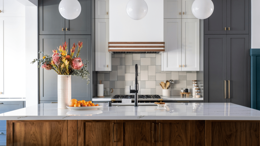 Design elements combining wood, metal, and stone for a mixed materials kitchen trend.